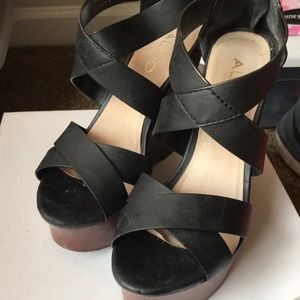 Women’s black cutout wedge shoes.